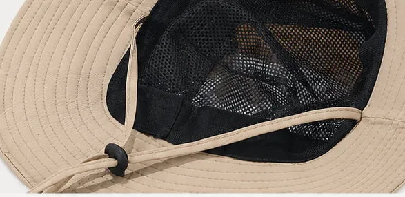 Inside view of the bucket hat showing the black mesh lining and the chin cord with its toggle
